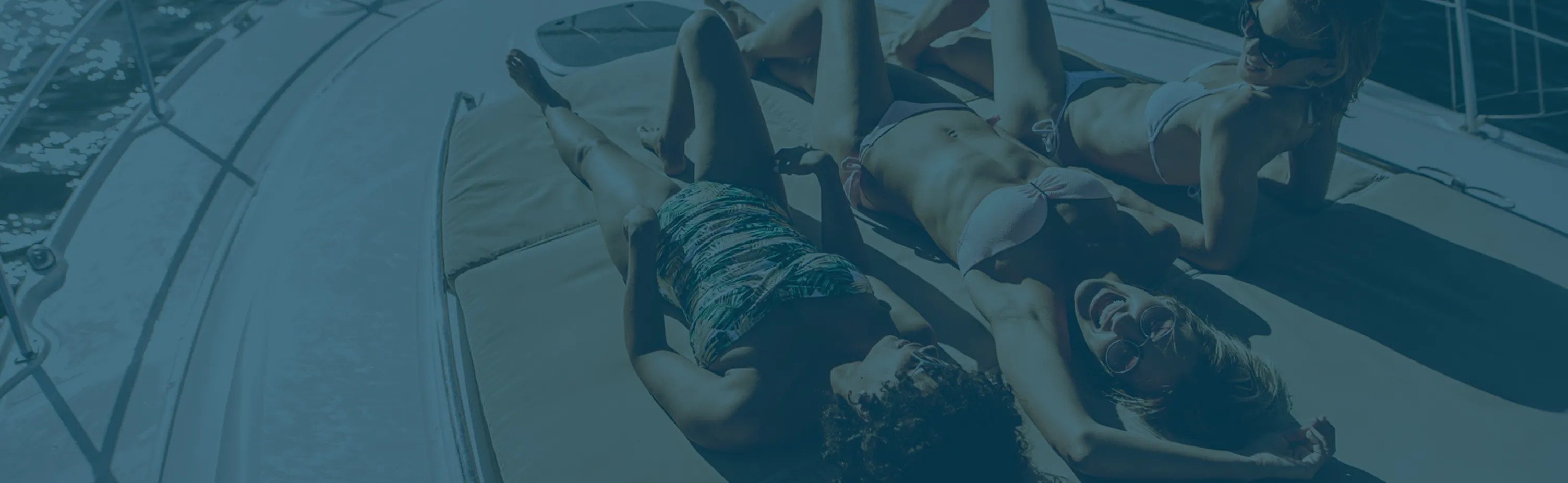 Guests relaxing on a boat deck — browse available boat rentals with Big Boat Rentals